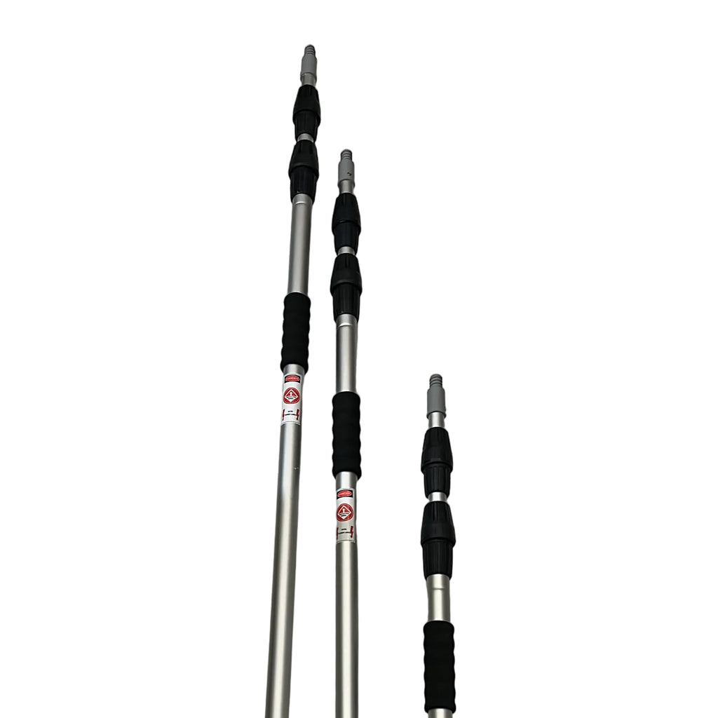 Three silver telescopic metal poles with black foam grips and yellow end fittings, laid out on a white marble-patterned tile floor.