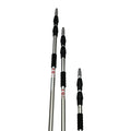 Three silver telescopic metal poles with black foam grips and yellow end fittings, laid out on a white marble-patterned tile floor.
